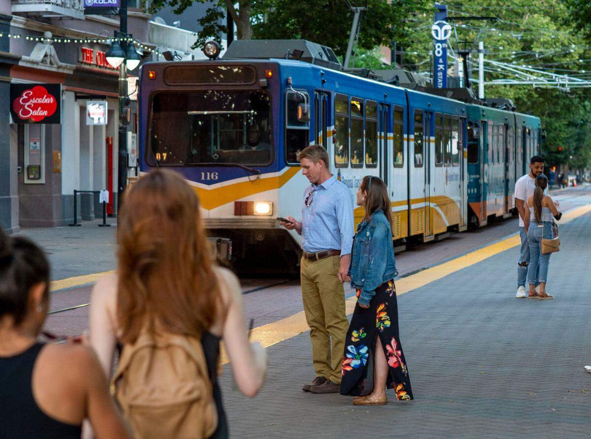 People walk near the 8th and K Street light rail station in downtown Sacramento in 2021. Measure A includes funding for an extension of light rail lines to Elk Grove, Citrus Heights and Sacramento International Airport.