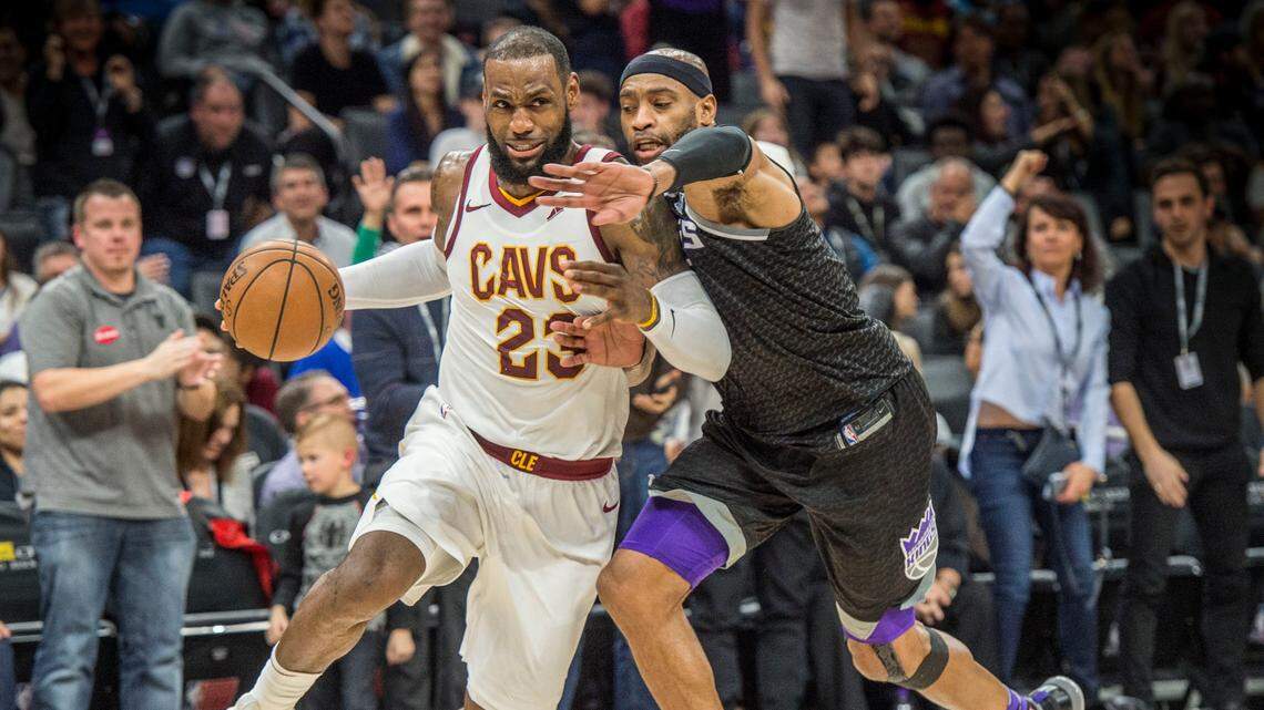 FILE -- Sacramento Kings guard Vince Carter (15) defends the Cleveland Cavaliers forward LeBron James (23) as he drives to the basket and misses a shot on Wednesday, Dec. 27, 2017, at the Golden 1 Center in Sacramento, Calif..