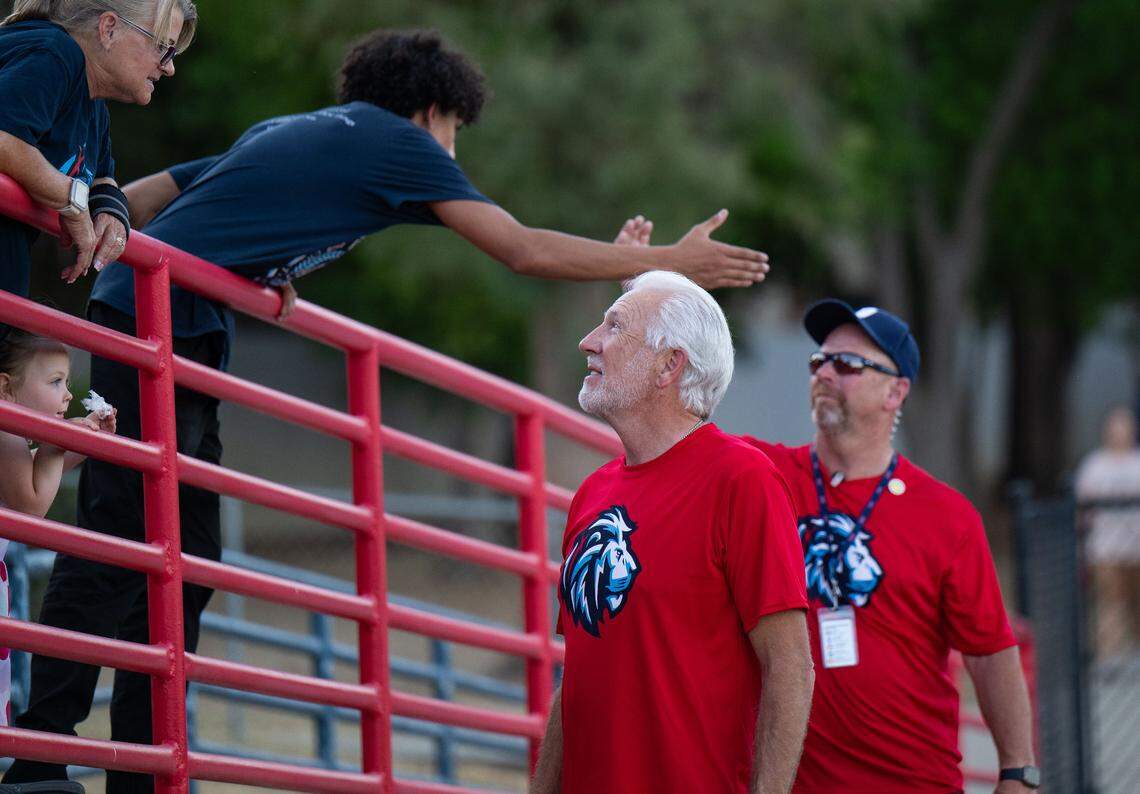 Destiny Church Pastor Greg Fairrington talks with people in the stands before the Destiny Christian Lions play the Linden Lions on Friday.