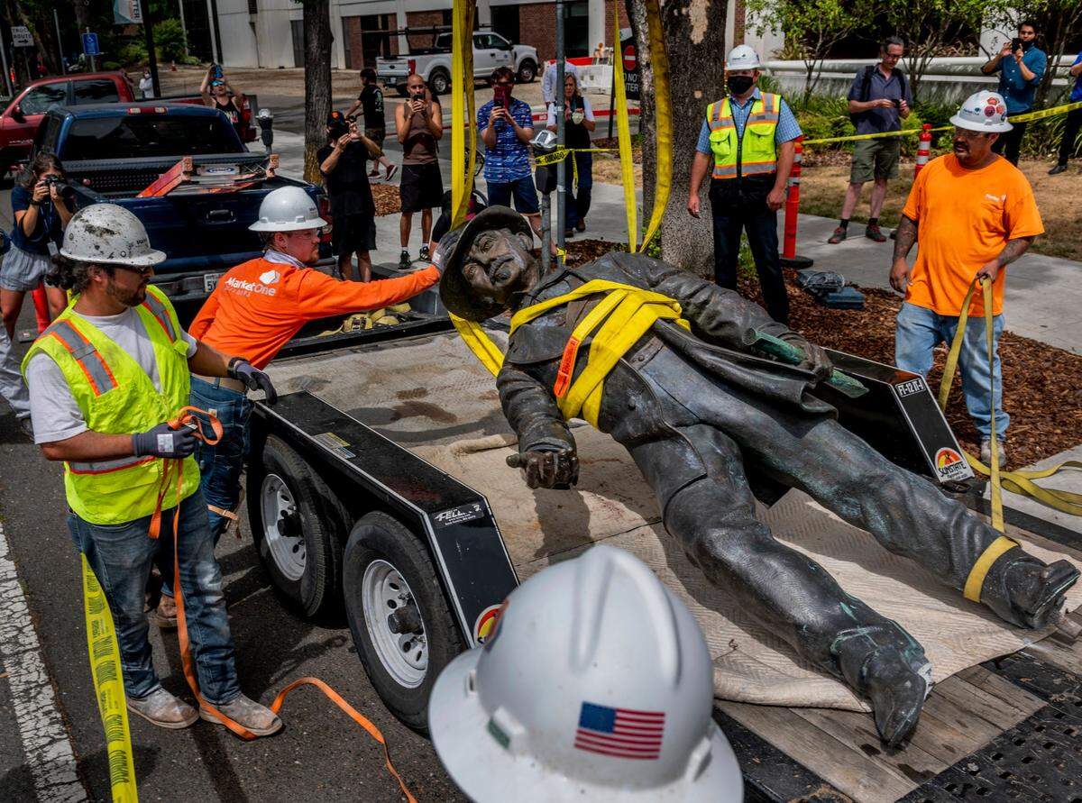 Workers remove a statue of John Sutter, a Swiss settler who built the first European settlement on the site of the city of Sacramento, outside Sutter hospital in midtown on Monday, June 15, 2020. Some historical accounts describe Sutter as using Native Americans as slaves and raping Native American girls as young as age 12.