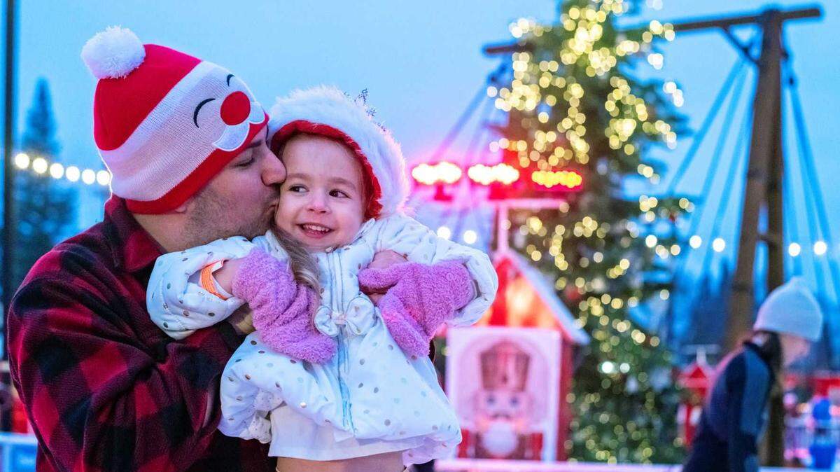 Eric Snook kisses his daughter Nora Snook of Snook’s Chocolate Factory on the old ice rink in Folsom. Previously, the Folsom Ice Rink has been around the turntable in the Historic District Plaza, but for this year the rink is moving slightly below the turntable on Leidesdorff Street.