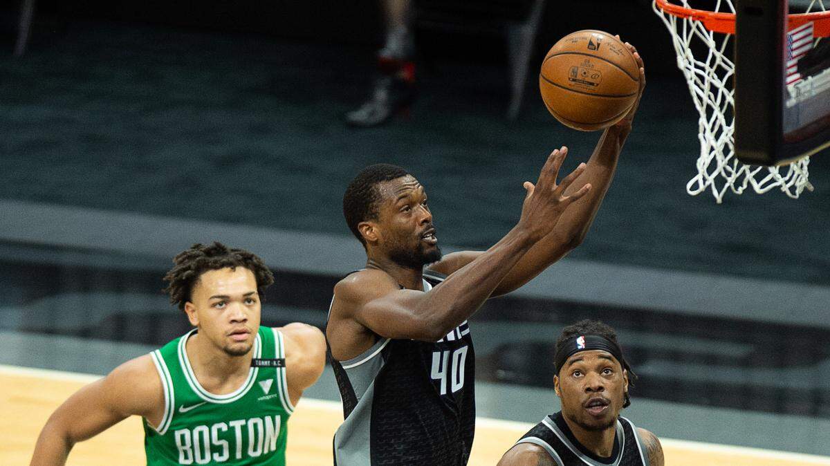 Sacramento Kings forward Harrison Barnes (40) drives to basket past Boston Celtics guard Carsen Edwards (4) and Boston Celtics center Daniel Theis (27) in the second quarter during a game at Golden 1 Center on Wednesday, Feb. 3, 2021 in Sacramento.