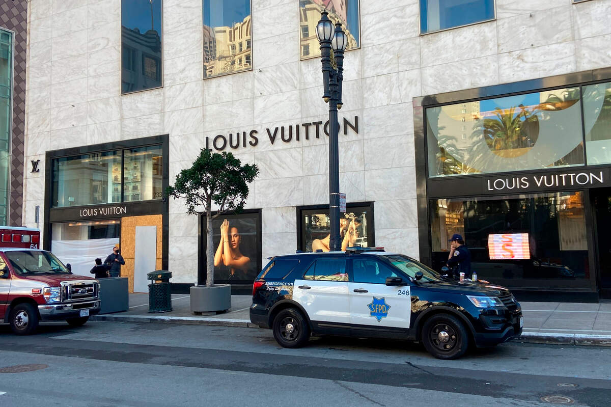 Police officers and emergency crews park outside the Louis Vuitton store in San Francisco’s Union Square on Nov. 21, 2021, after looters ransacked businesses.