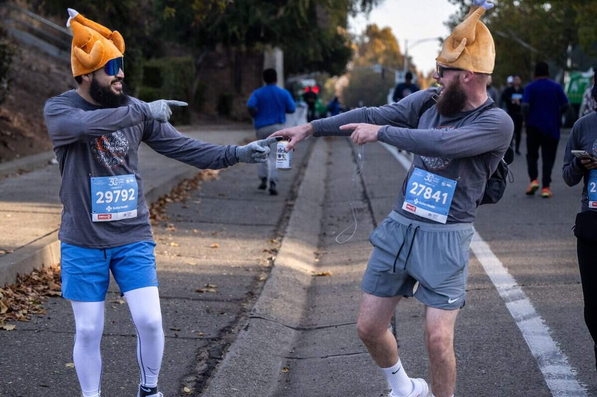 Friends David Rojas and Marcus Savedra participate in the 30th annual Run to Feed the Hungry on Thursday in East Sacramento.