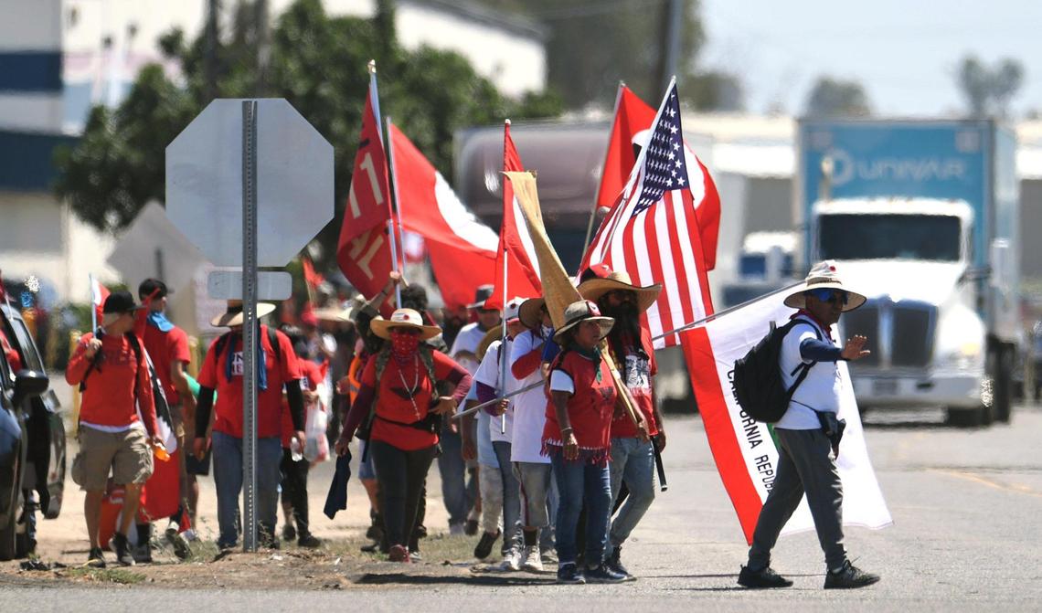Marchers in the UFW’s March For The Governor’s Signature march down a street in Calwa, south of Fresno, on Aug. 11.