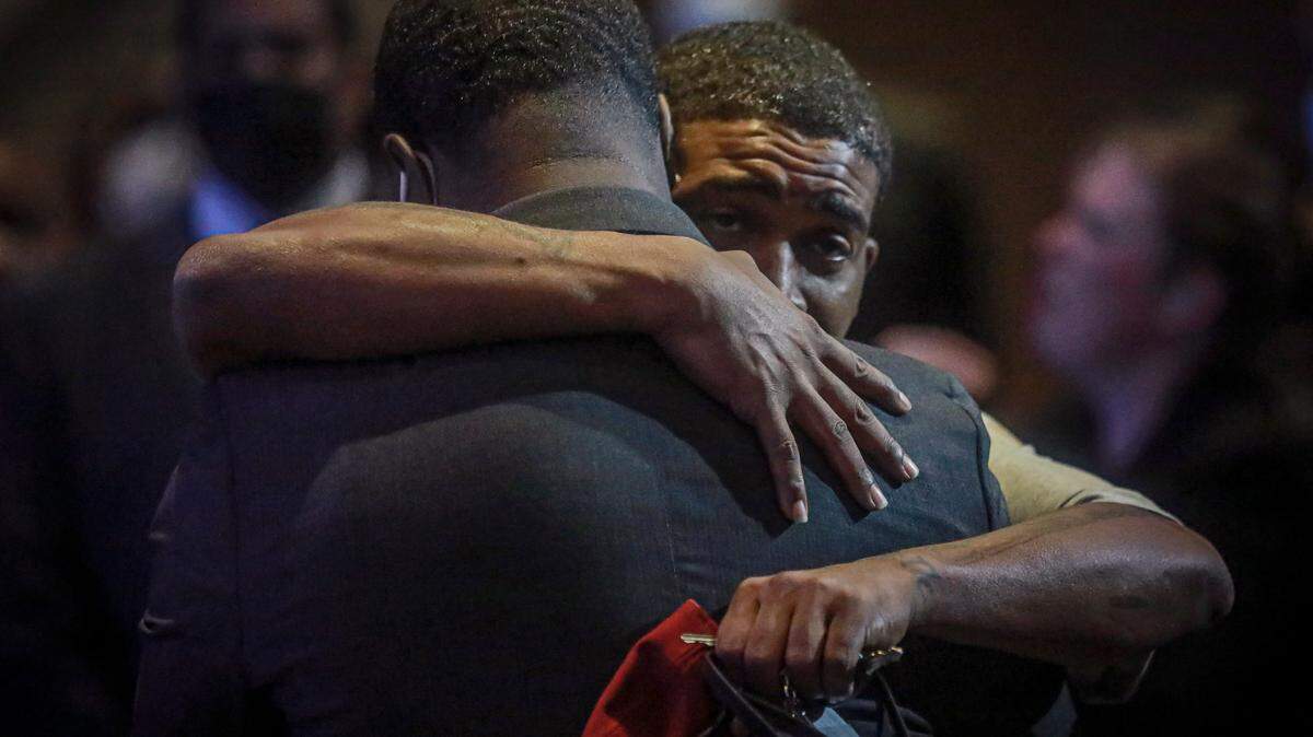 Brandon Williams, left, is embraced during a memorial for his uncle George Floyd at North Central University, Thursday, June 4, 2020, in Minneapolis. Floyd died May 25 after being restrained by police in Minneapolis. (AP Photo/Bebeto Matthews)