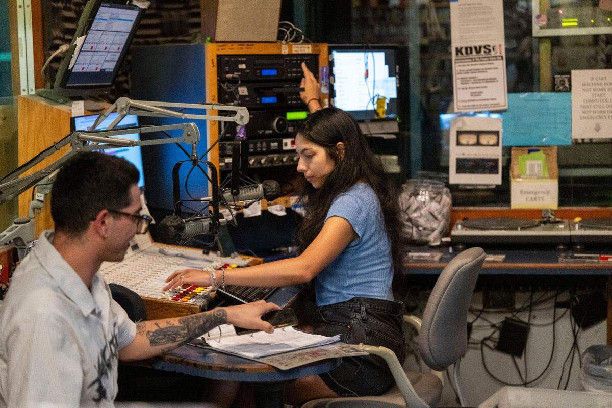 Celine Collazo, right, a KDVS radio DJ that goes by “DJ Moon,” hosts her radio show called Insomnia with help from her boyfriend, Vicente Valdebenito, left, who goes by “DJ Bellako” in the basement at UC Davis last month. KDVS has been broadcasting for 60 years and will soon leave its basement spot under Freeborn Hall.