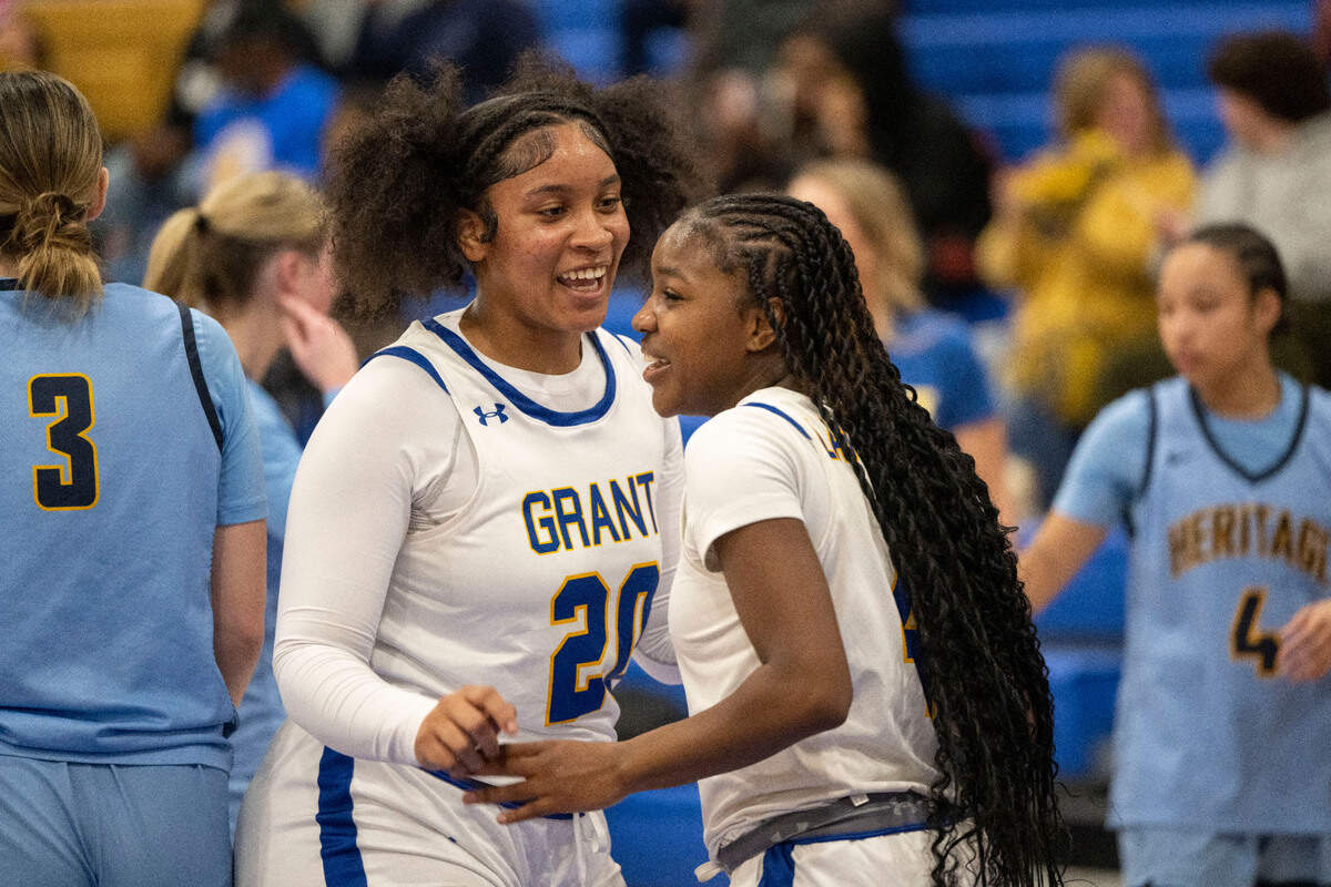 Grant High School’s Oranell Latham celebrates with Nerissa Hamilton after she stole the ball during the first half against Heritage High in the CIF Northern California regional Division III girls basketball playoff game Tuesday in Del Paso Heights.