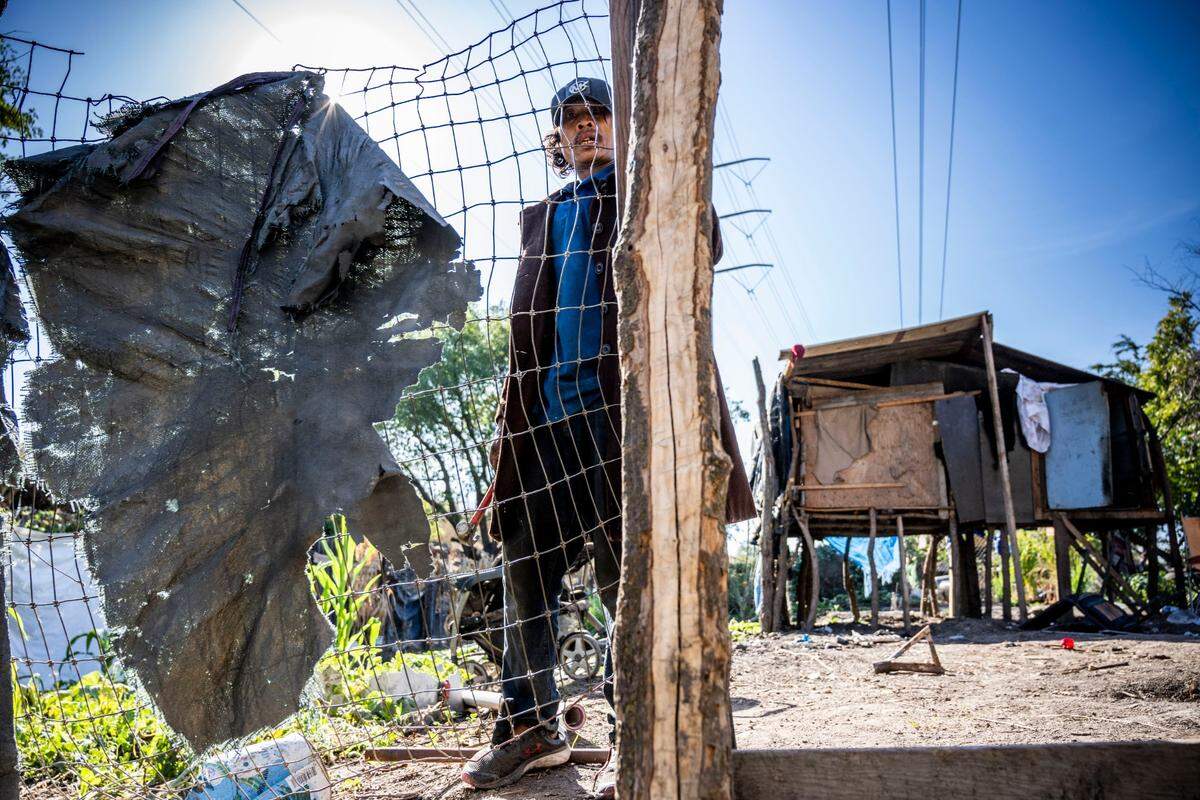 Joy Siribuoutxong, 48, removes fencing from his encampment on Morrison Creek in south Sacramento on Thursday, Oct. 6, 2022, before the homeless village was removed by the Department of Utilities to levee work can begin. Siribuoutxong and his brothers gathered whatever belongings they could carry with them before their home, elevated to counter creekside flooding, was destroyed. About 50 homeless immigrants from Southeast Asia were raising chickens and crops from corn to cannabis in the area.