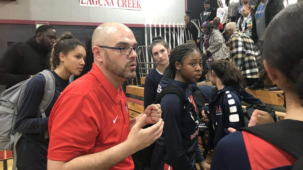 San Joaquin Memorial coach Cory Fischer congratulates his team after beating Laguna Creek in Northern California Division II play.