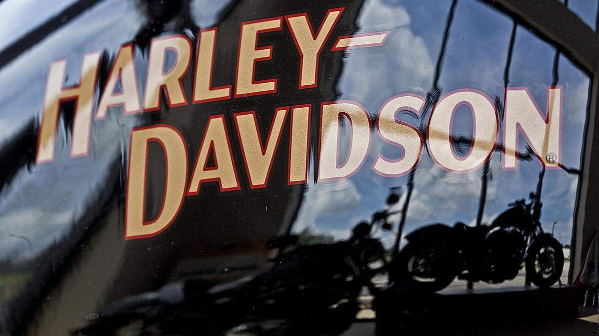 Motorcycles are reflected in a gas tank at a Harley Davidson dealer in New Berlin, Wis., on July 20, 2010.