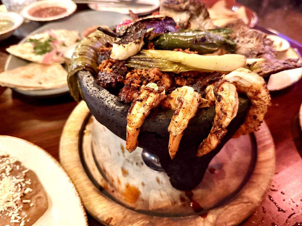 Mexican restaurant Casa Lola at 1132 16th St. in Sacramento serves a molcajete mixto, a sizzling lava stone mortar filled with meats, shrimp, cactus paddle and vegetables on Dec. 28, 2025.