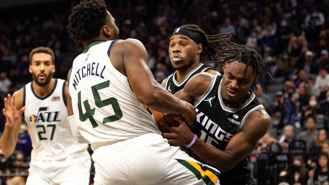 Sacramento Kings guard Davion Mitchell (15) wrestles the ball from Utah Jazz guard Donovan Mitchell (45) during the second period of their NBA regular season home opener Friday, Oct. 22, 2021, at Golden 1 Center in downtown Sacramento.