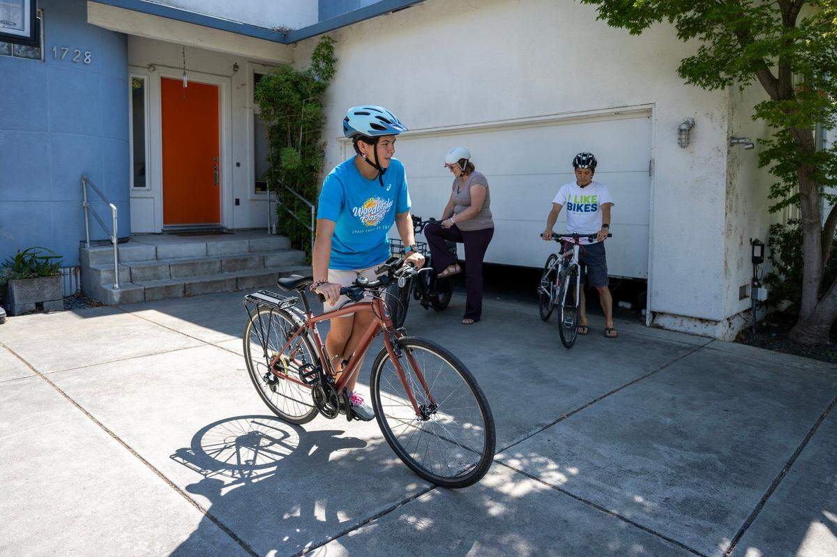 Alena Wong and her parents, Kevin and Taryn Wong, leave their home for a ride last month. Four years ago, Alena Wong was hit by a car as she rode her bike to school, through the intersection of Sutterville Road and Mead Avenue in Sacramento in October 2019.