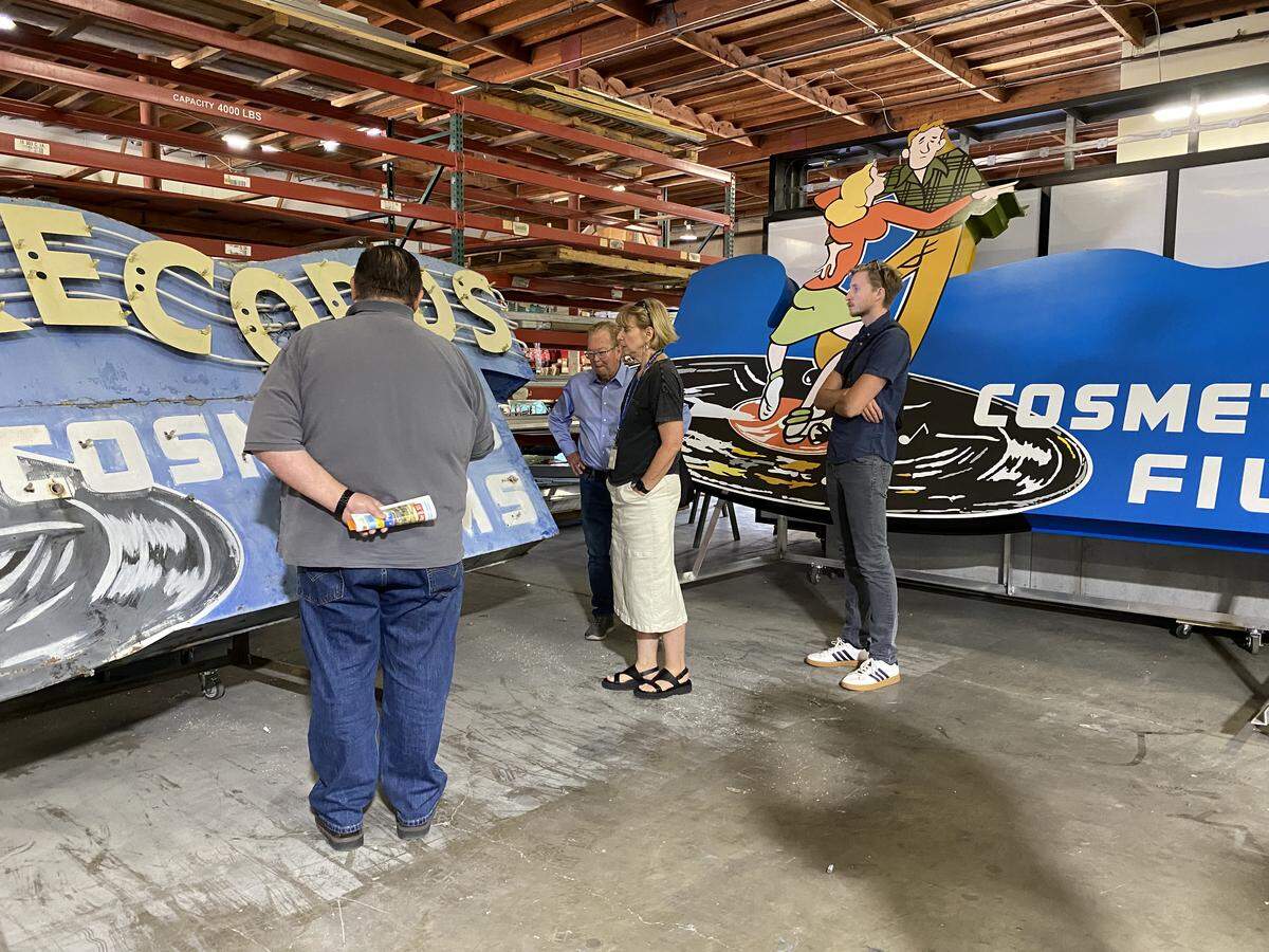 A group from the city of Sacramento visited Alpha Architectural Signs where they viewed the original and the replica Tower Records signs in July 2024. The people in the photo are, left to right: Jason Lane, general manager for Alpha; Bruce Monighan, the city’s urban design manager; Marcia Eymann, who was city historian at the time and has since retired; and Henry Feuss, who works in preservation for the city.