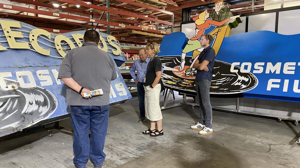 A group from the city of Sacramento visited Alpha Architectural Signs where they viewed the original and the replica Tower Records signs in July 2024. The people in the photo are, left to right: Jason Lane, general manager for Alpha; Bruce Monighan, the city’s urban design manager; Marcia Eymann, who was city historian at the time and has since retired; and Henry Feuss, who works in preservation for the city.