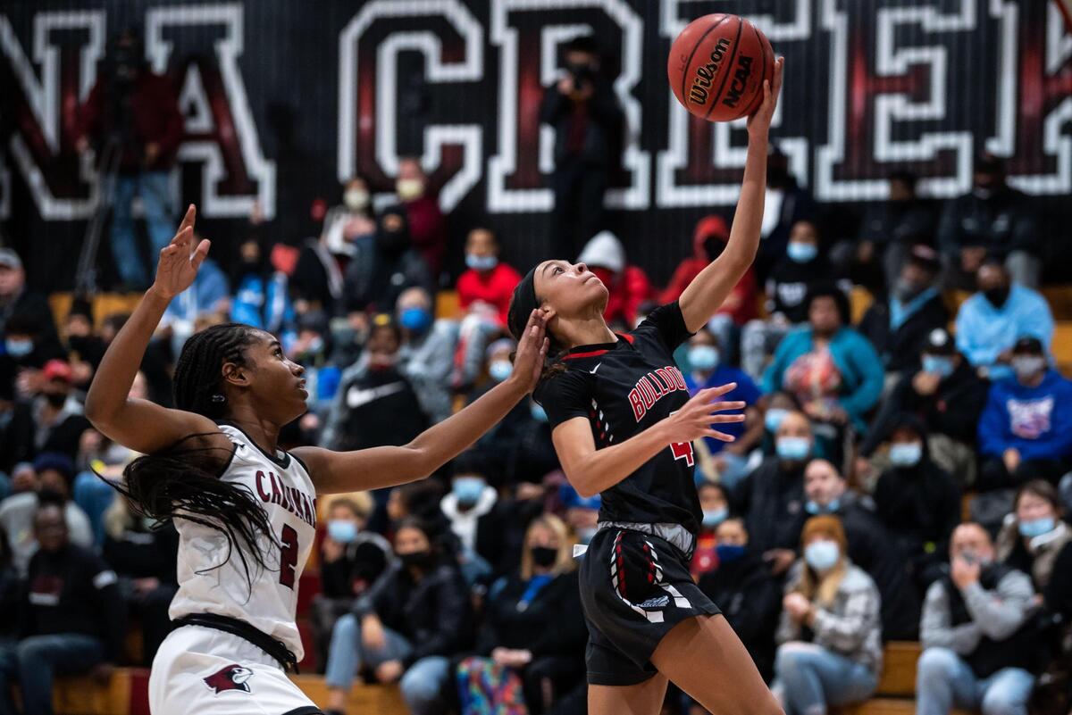 Folsom guard Makayla Jackson (4), right, goes up to score two points past Laguna Creek forward/guard Ahrray Young (2) after stealing the ball during the third period at the high school girls basketball game Friday, at Laguna Creek High School in Elk Grove. The two teams were undefeated going in at seven wins apiece, but Folsom walked away with a 98-59 win.