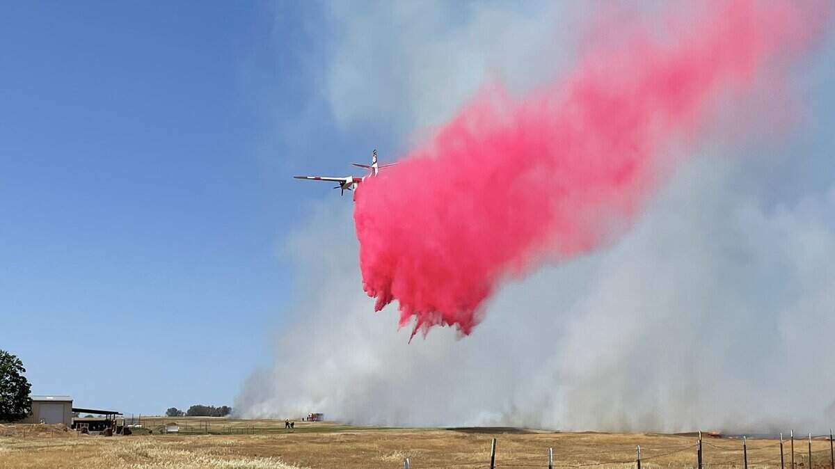 A Cal Fire tanker drops retardant over the Gunnison Fire, burning north of Chico on Saturday afternoon.