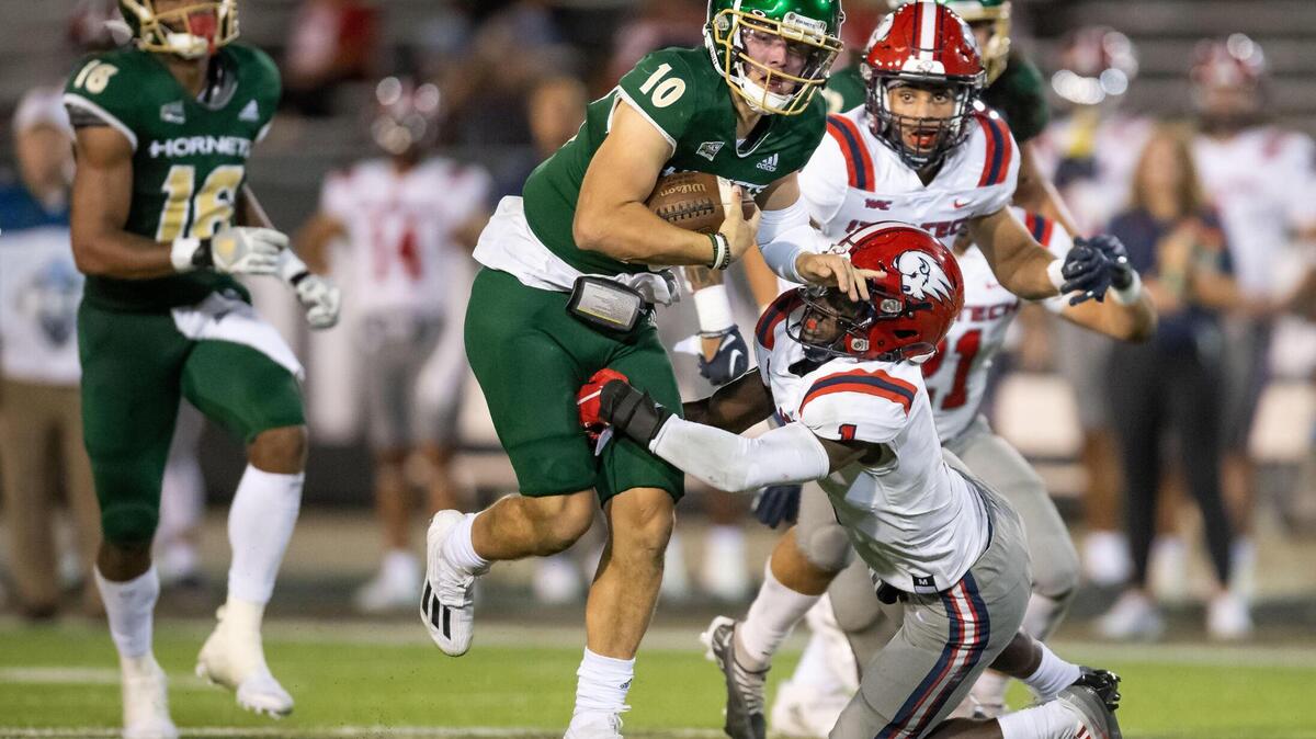 Sacramento State quarterback Asher O’Hara (10) fends off Utah Tech defensive back Tyrell Grayson (1) on a keeper in the second quarter of the NCAA college football game Saturday, Sept. 3, 2022, at Hornet Stadium in Sacramento.