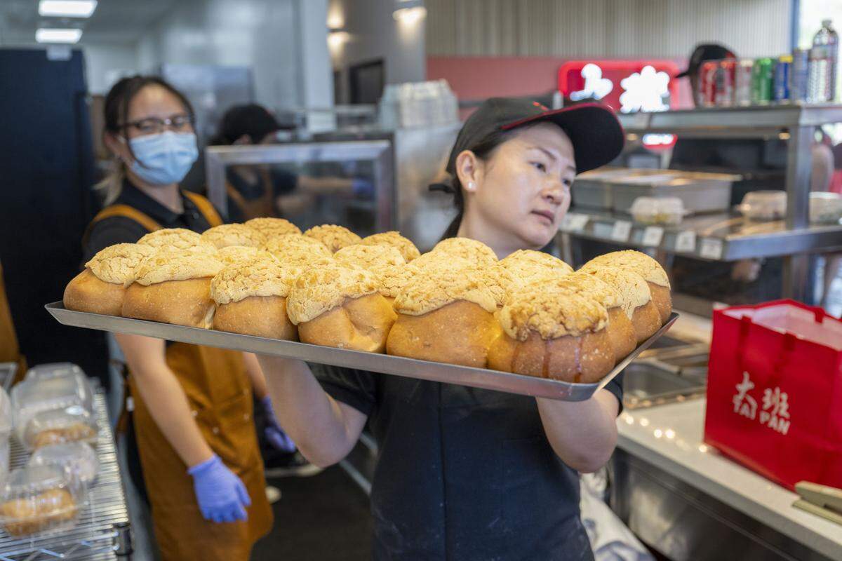 Baked buns are carried to a display during a soft opening of Tai Pan dim sum restaurant in Sacramento on Tuesday, Sept. 9, 2025.