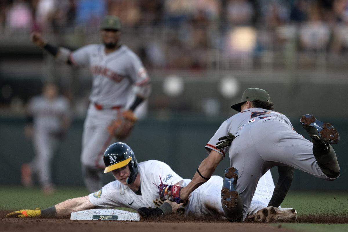 San Francisco Giants shortstop Willy Adames tags out baserunner Henry Bolte of the Athletics on a throw by Giants catcher Daniel Susac as Bolte tried to steal second base in the bottom of the fourth inning Friday at Sutter Health Park in West Sacramento.