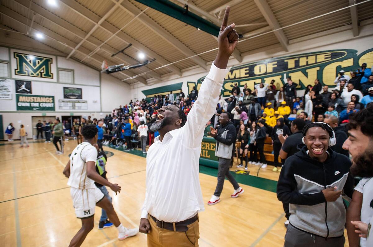 Monterey Trail Mustang head coach Robert Fields points skyward after his team beats Grant at the high school boys basketball game Wednesday, Feb. 1, 2023, at Monterey Trail High School in Elk Grove.