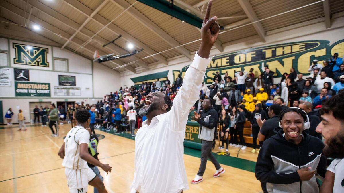 Monterey Trail Mustang head coach Robert Fields points skyward after his team beats Grant at the high school boys basketball game Wednesday, Feb. 1, 2023, at Monterey Trail High School in Elk Grove.