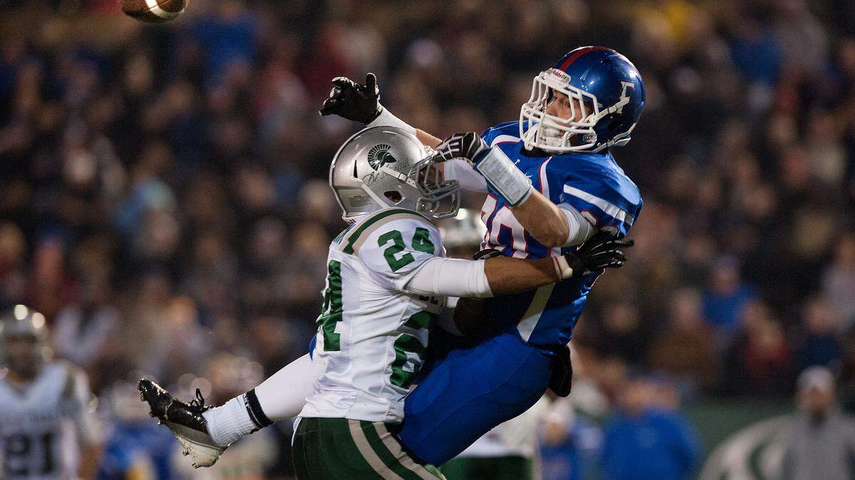 De La Salle’s Allan Marion, left, and Folsom’s Troy Knox collide as they reach for a pass during the Northern California Regional Open Division championship game Dec. 8, 2012 at Hornet Stadium in Sacramento.