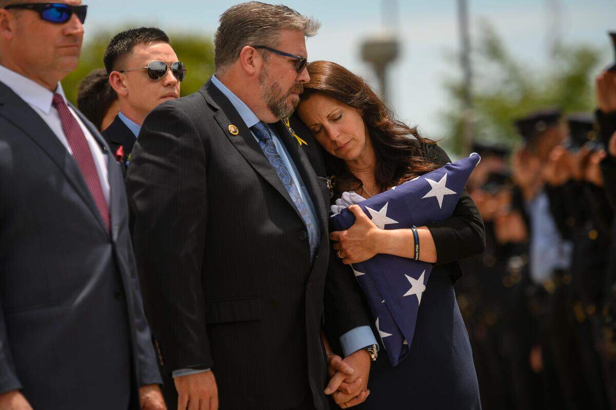 2. Kelley O’Sullivan leans into her husband Denis O’Sullivan while their daughter’s casket is loaded into the hearse following the memorial service for fallen officer Tara O’Sullivan at Bayside Church Adventure Campus, Thursday, June 27, 2019.