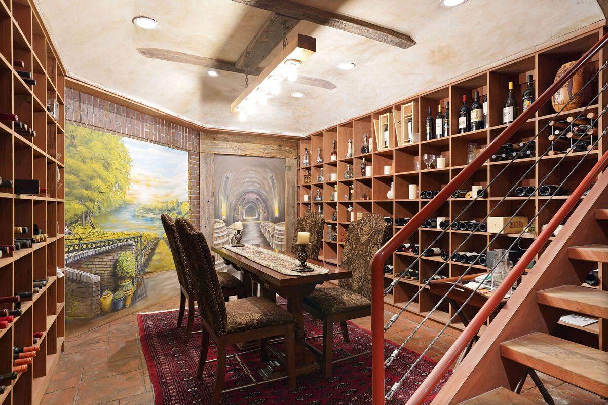 The 2,000-bottle wine cellar has murals painted by local artist Robert Lindsey.