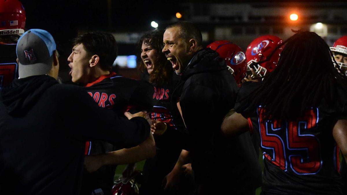 Mira Loma head coach Jesse Collins and his Matadors celebrate their 48-34 CIF Sac-Joaquin Division VIII semifinal victory against Delta on Friday, Nov. 21, 2025, at El Camino High School in Arden Arcade, Calif.