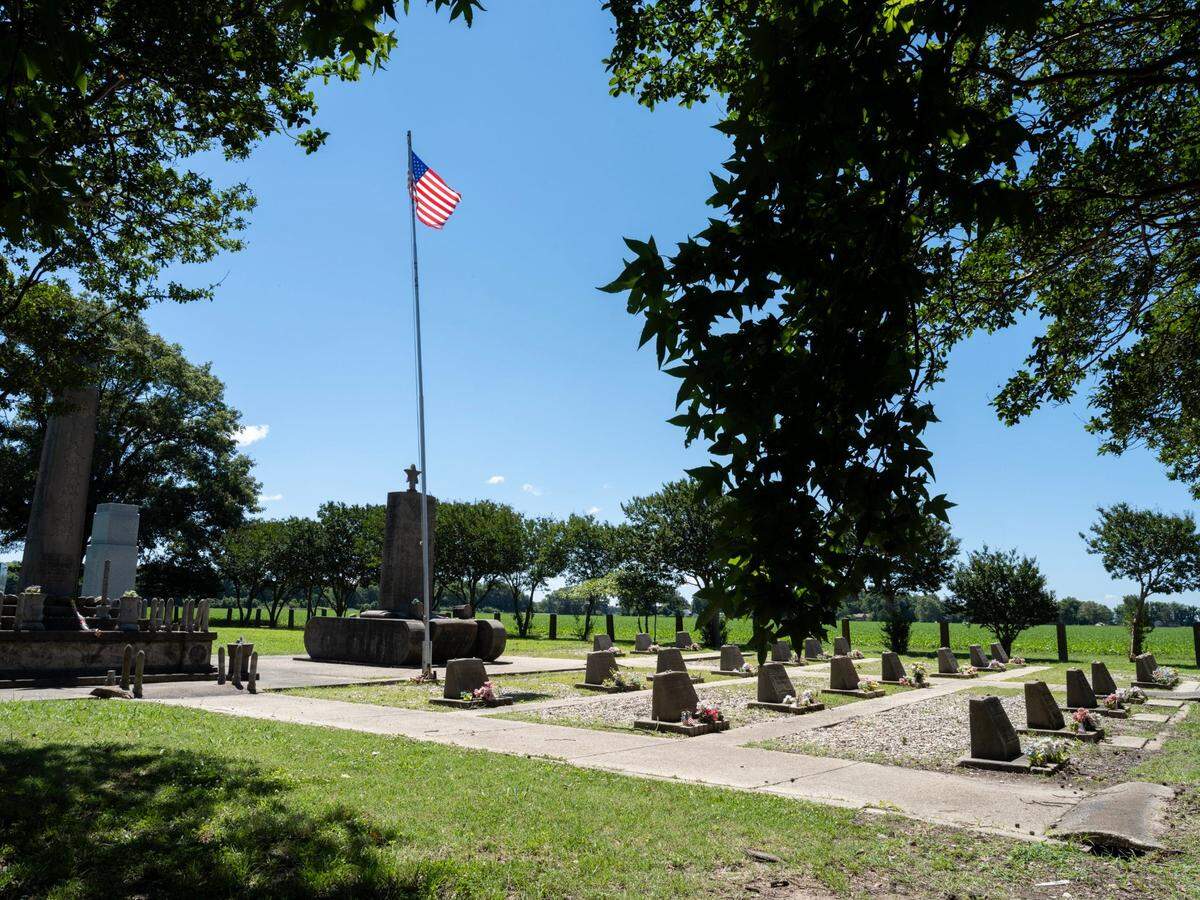 A memorial statue of an armored tank, constructed by the incarcerated honor Japanese Americans who died fighting in Europe during World War II in the U.S. Army’s 100th Battalion 442nd Company Regiment, stands at the memorial cemetery at the Rohwer incarceration camp in Arkansas during a visit by a group of Japanese survivors and their descendants last month.