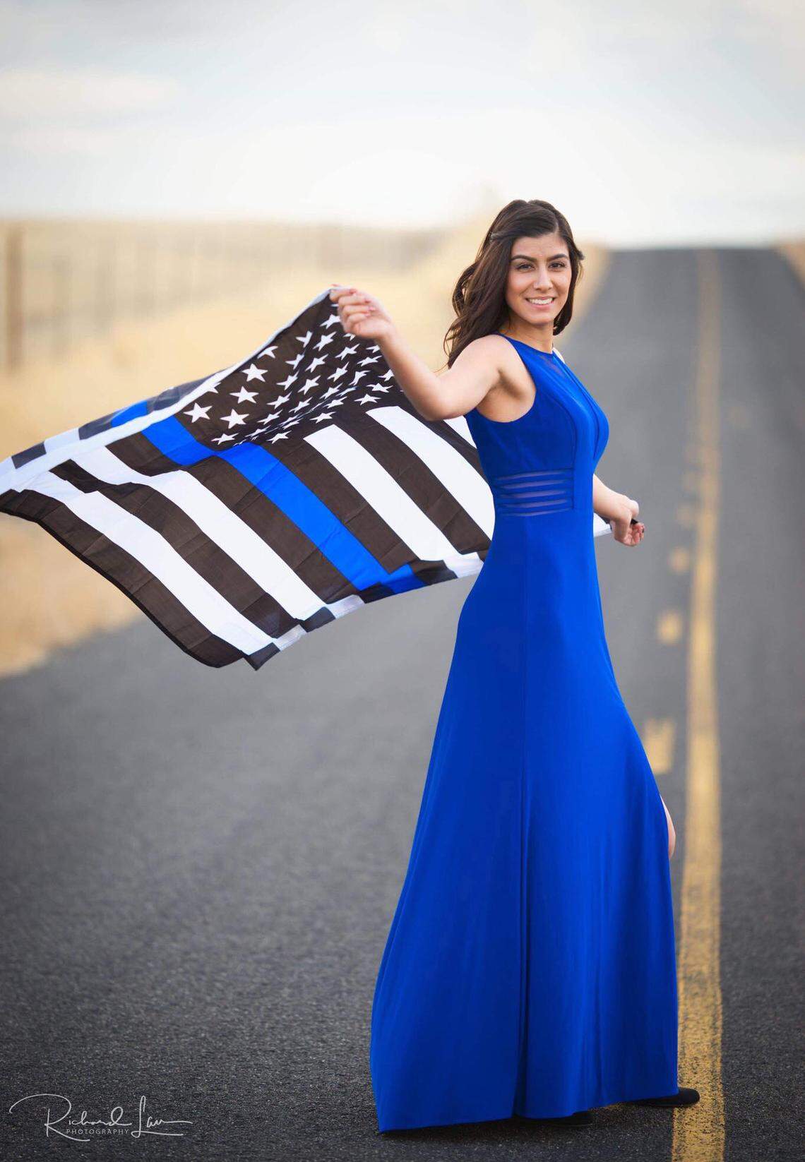 This portrait of Natalie Corona by Richard Laus shows the Davis Police officer who was killed in the line of duty on Thursday waving the Thin Blue Line American Flag. The flag’s manufacturer describes it as a “testament to the valor of police officers across the country.”