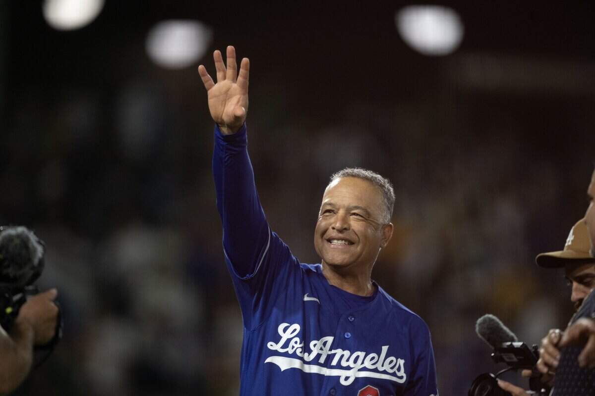 Los Angeles Dodgers manager Dave Roberts waves to the crowd after winning his 1,000th game as a manager after the Dodgers defeated the Athletics 9-3 at Sutter Health Park on Tuesday in West Sacramento.