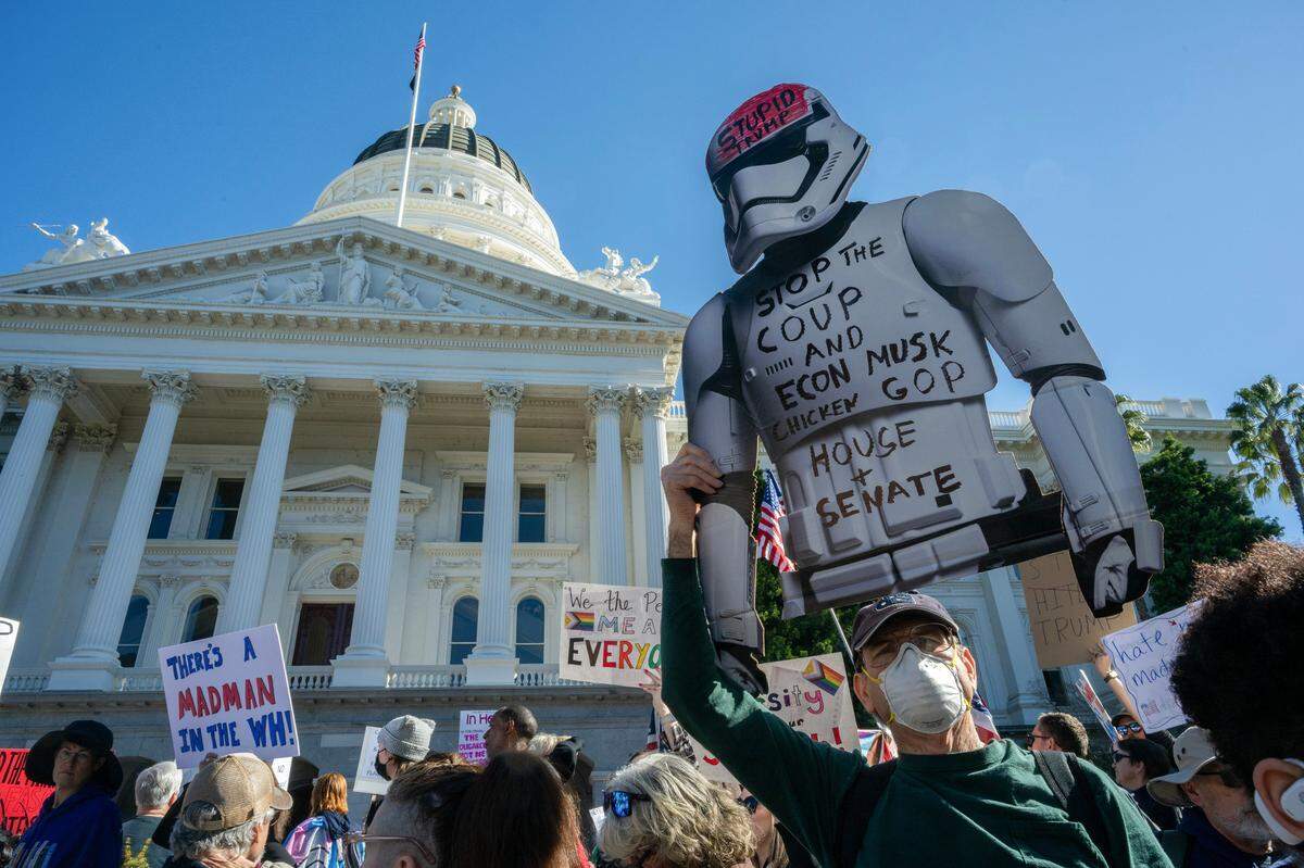 Hundreds of demonstrators in Sacramento hold signs and chant for causes at a protest against President Donald Trump and his adviser Elon Musk at the Capitol on Feb. 5.