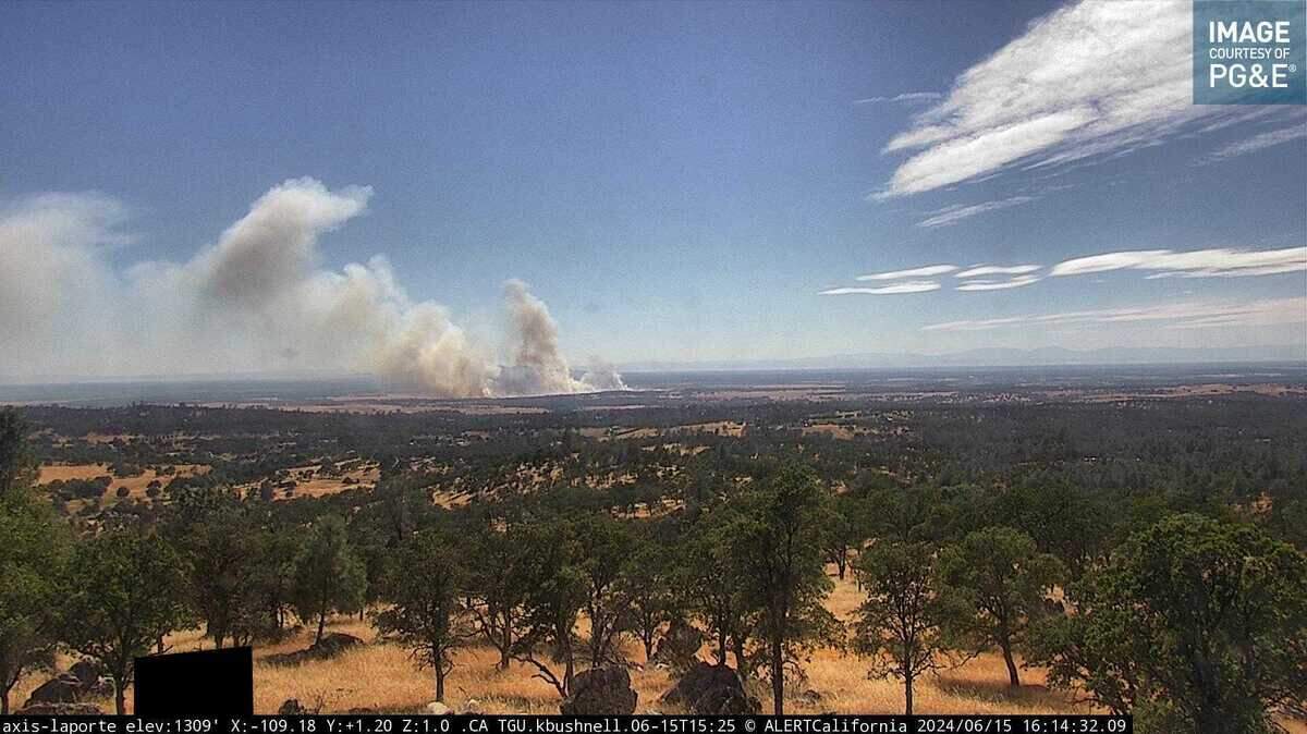 Smoke from the Junes Fire is seen Saturday, June 15, 2024, from a wildfire surveillance camera in Bangor in Butte County. The fast-spreading grass fire has charred 50 acres and two structures and prompted evacuations, according to authorities.