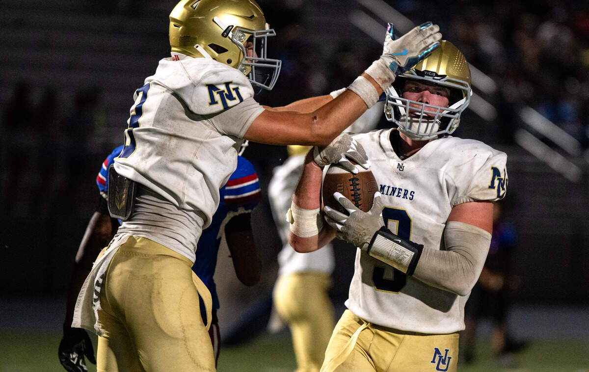 The Nevada Union Miners' Rhyder Eelkema (3) congratulates Brandon McCallum (9) after he scores a 2-point conversion in the second quarter against the Christian Brothers Falcons in Sacramento on Friday, Sept. 5, 2025.