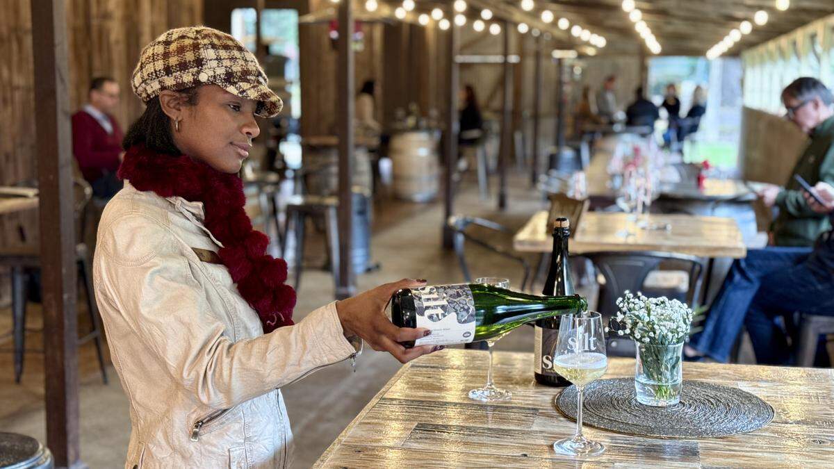 Mia Daniels pours a glass of Sparkling Chenin Blanc at Silt Winery in Clarksburg on Sunday, Dec. 21
