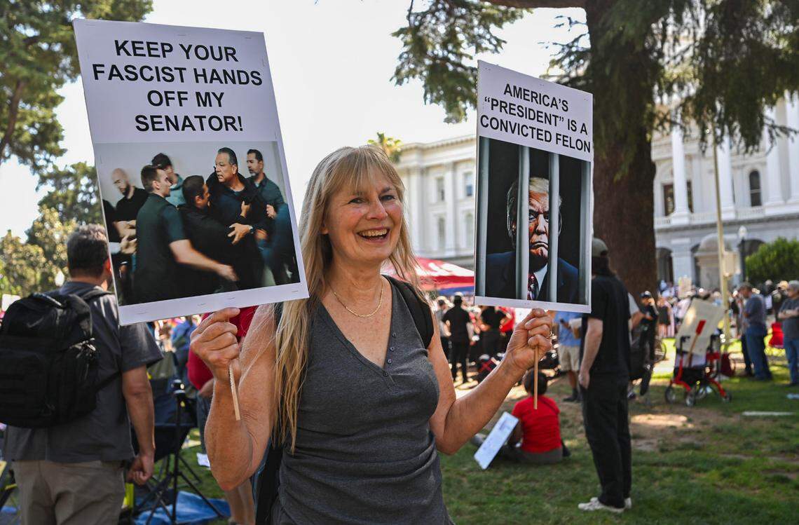 Susan Sparks of Fairfield holds a sign that says “Keep your fascist hands off my senator” as she attends the “No Kings” protest at the California Capitol in Sacramento on Saturday.