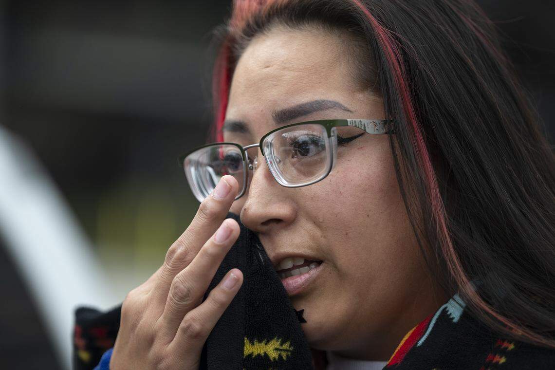 SiSi Rose, a member of the Sisseton-Wahpeton and Cheyenne River tribes, wipes tears away as she speaks to the Sacramento Bee during a protest against Immigration and Customs Enforcement outside the John Moss Federal Building in Sacramento on Sunday. Rose says ICE’s actions have made her afraid for Native American people.
