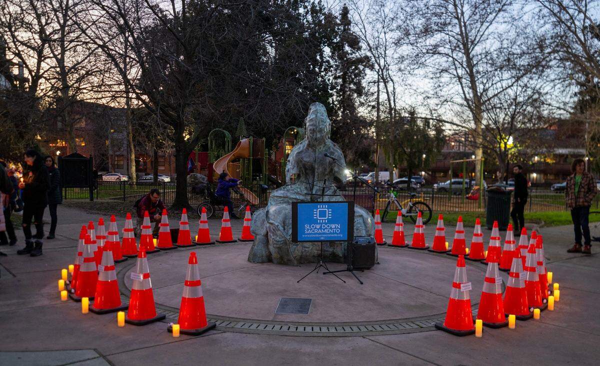 Cones form a circle in the center of Fremont Park to represent people who died in fatal traffic collisions on Sacramento streets during a vigil hosted by Slow Down Sacramento on Thursday. Of the 33 cones, 32 bore the names of a person who died in 2024. The final cone was left blank to represent those who might have been overlooked or those who might still die of injuries sustained in a crash in 2024.