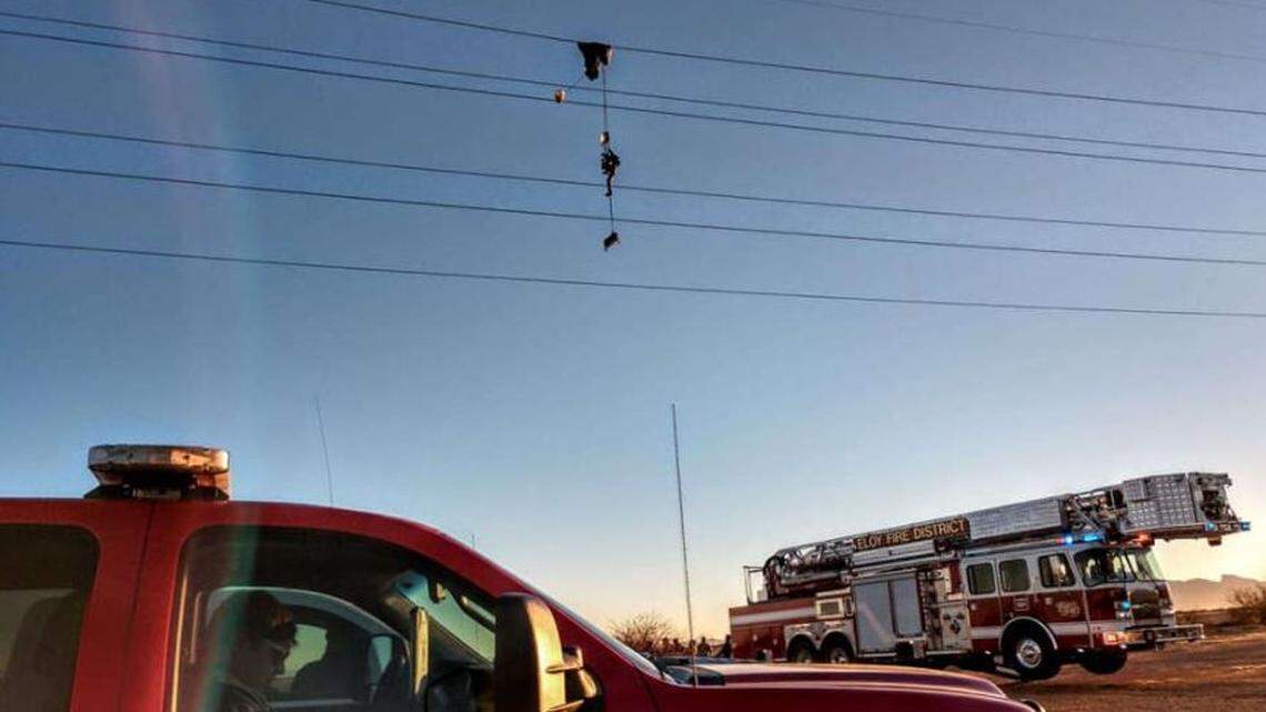 A parachutist on a military training exercise ended up dangling from high-voltage power lines for hours Friday before being rescued near Arizona City, Arizona.
