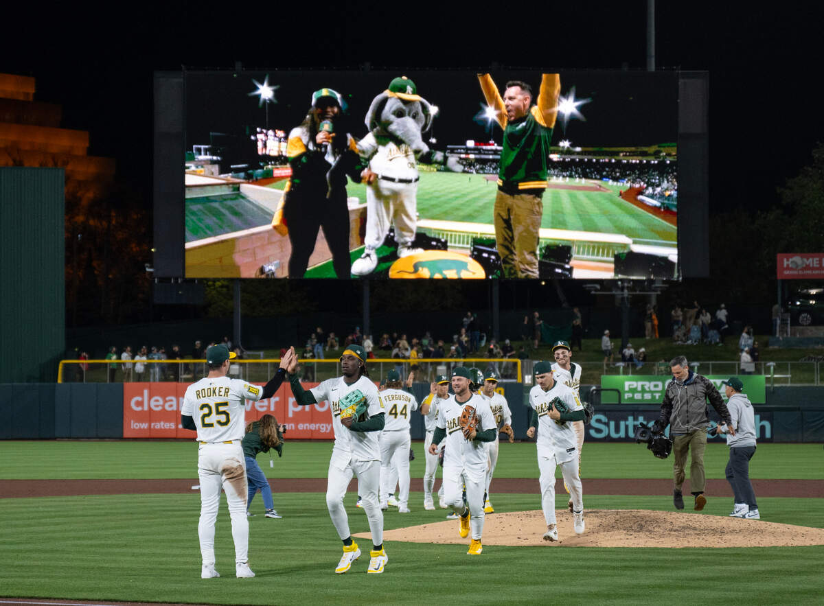 The Athletics players run off the field after beating the San Diego Padres for their first home victory on Tuesday at Sutter Health Park in West Sacramento.