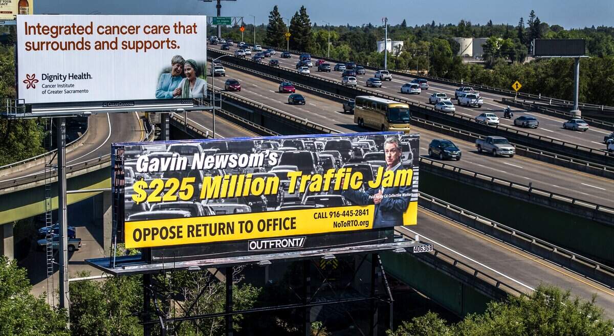 A billboard opposing Gov. Gavin Newsom’s return-to-office order, visible to the eastbound commuters along the Capital City Freeway, stands in West Sacramento on Thursday. The billboard is the latest effort by state workers against the order.