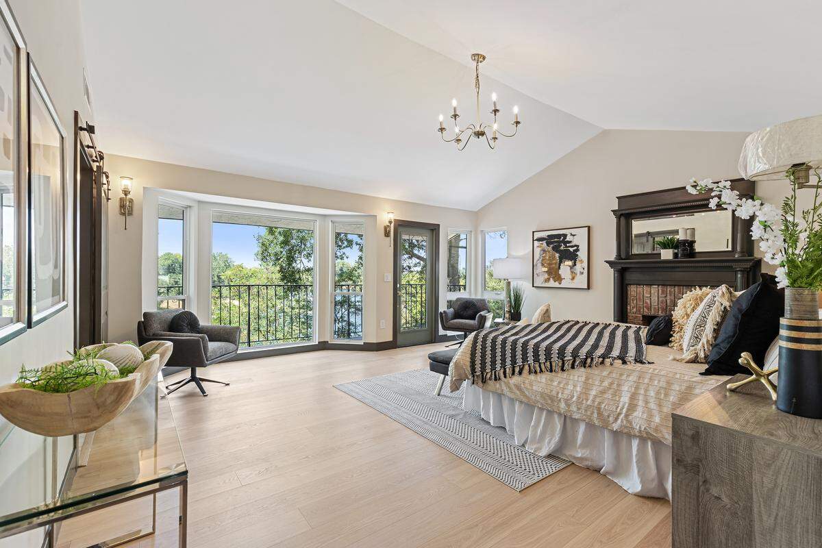 The upstairs primary suite offers a private terrace and spa-like bath with a deep-soaking tub beside the window, where morning sun and the sound of the river create the perfect personal retreat.