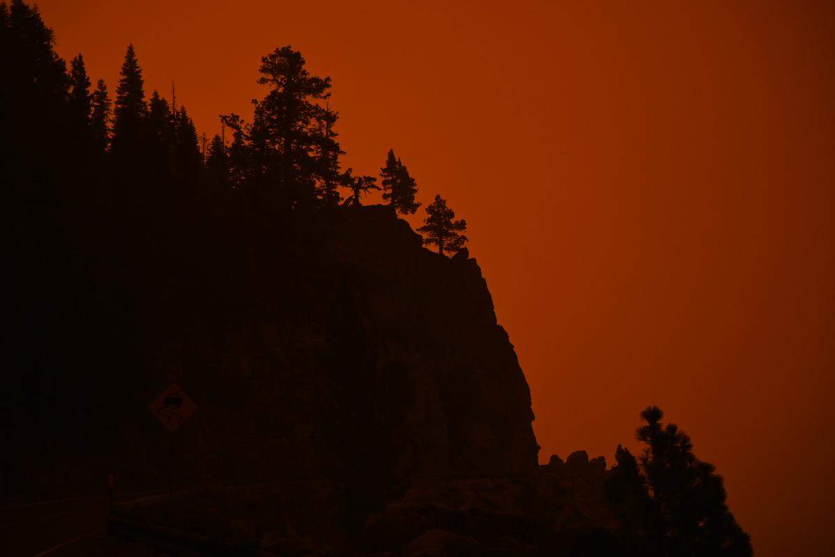 The sky glows red at Echo Summit on Highway 50 as the Caldor Fire burns to the west on Sunday.