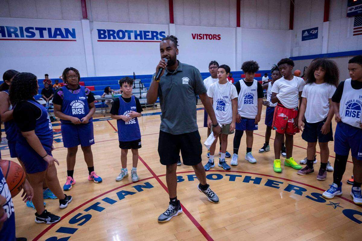 Kings and Queens Rise Commissioner Kenneth Duncan speaks to kids and parents before a basketball game earlier this month at Christian Brothers High School.