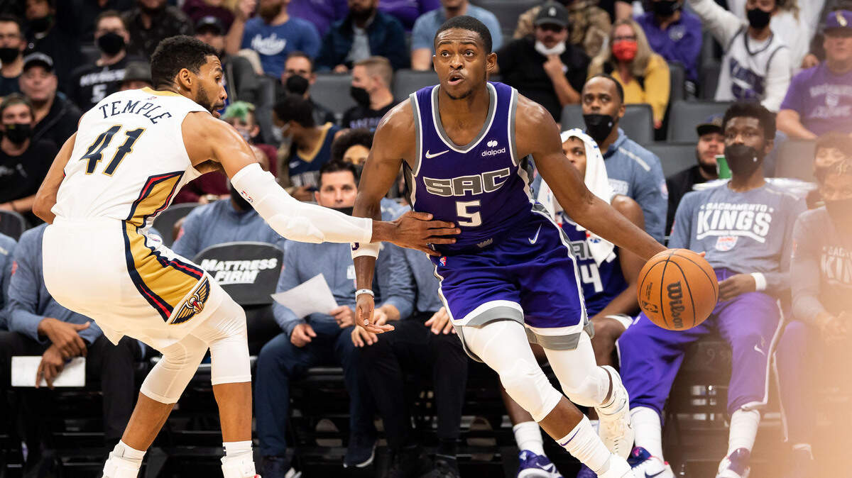 Sacramento Kings guard De’Aaron Fox (5), right, dribbles against New Orleans Pelicans forward Garrett Temple (41) during the fourth period of the NBA basketball game Wednesday, Nov. 3, 2021, at Golden 1 Center in Sacramento. The Kings beat the Pelicans 112-99.