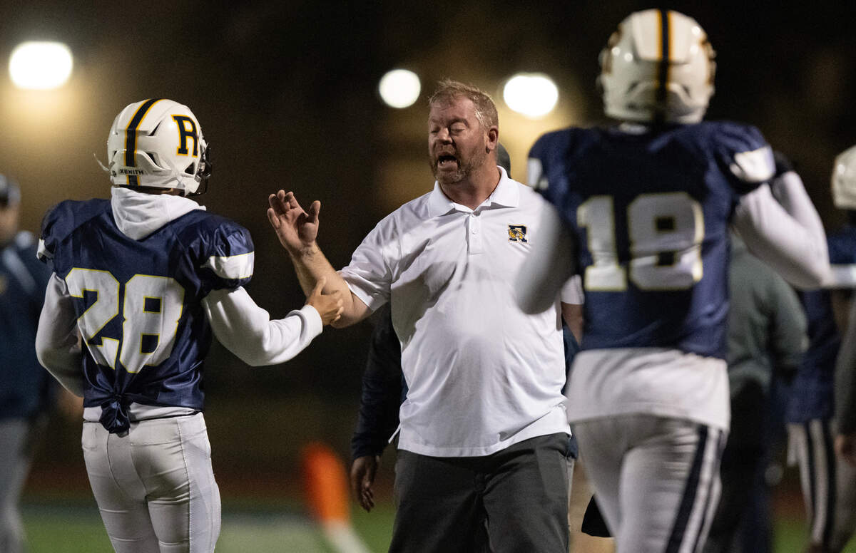 Rosemont Wolverines coach John Straw high fives his players, including kicker Ricardo Morales (28), after the team’s second touchdown in the first half against the Dixon Rams in the first round of the CIF Sac-Joaquin Division V section football playoffs on Friday, Nov. 3, 2023, at Rosemont High School.