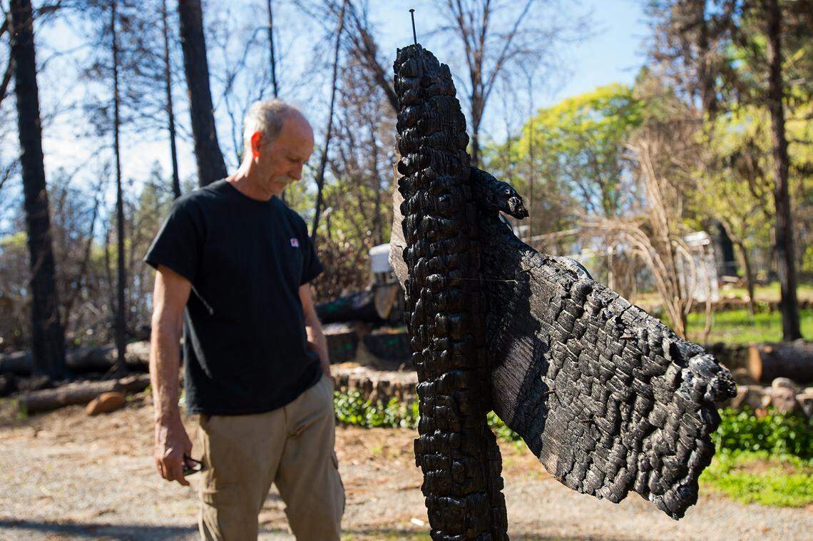 Stewart Nugent stands near the fire damaged address sign on his property on Monday, April 22, 2019 in Paradise. Stewart saved his and his neighbor’s homes during the Camp Fire.